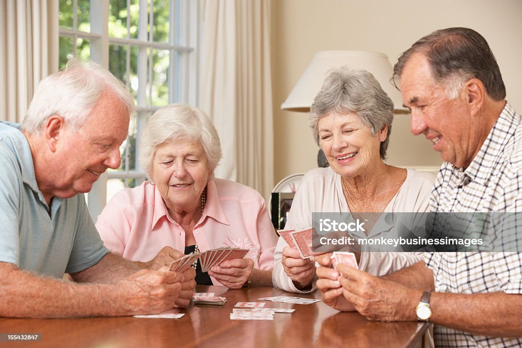 Pareja Senior disfrutando de juego de tarjetas en su hogar - Foto de stock de Tercera edad libre de derechos