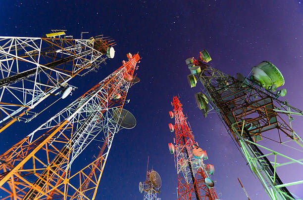 Ground view of telecommunication towers Telecommunication mast with microwave link and TV transmitter antennas in night sky . long exposure about 2-3 minutes communications tower broadcasting antenna telecommunications equipment stock pictures, royalty-free photos & images