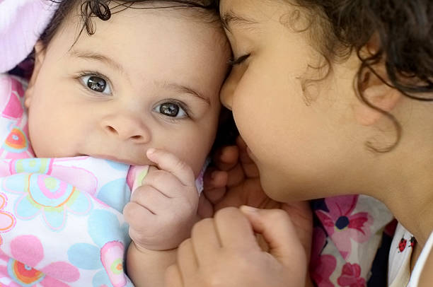 istock Portrait of Two Cuddling Sisters 155433106