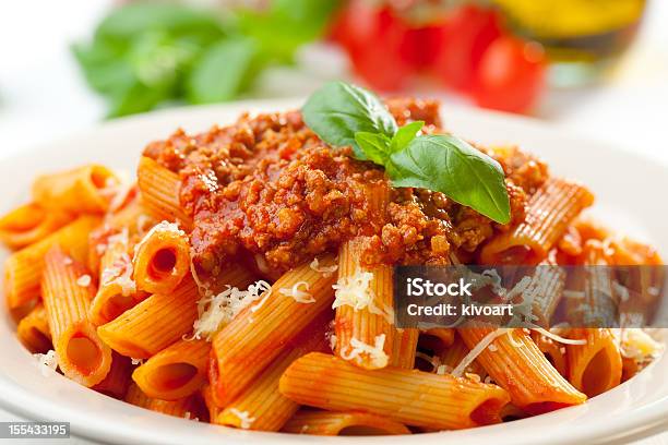 Closeup Of The Orangetoned Penne Bolognese Stock Photo - Download Image Now - Bolognese Sauce, Penne, Basil