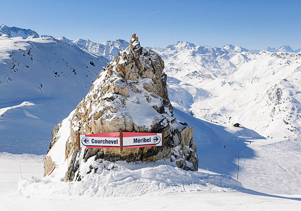 Courchevel and Meribel Ski Signs Signs on a ski slope in the Trois Vallees, in the French Alps, directing skiers towards Courchevel and Meribel. courchevel stock pictures, royalty-free photos & images