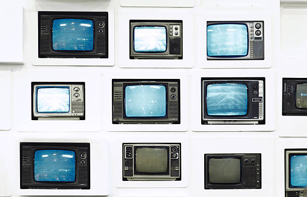 istock Many old vintage televisions on white wall 155433394