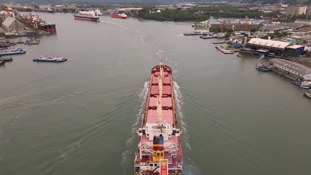 A cargo ship passing between ports