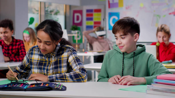 istock Shy teen boy looking at classmate 1554350646