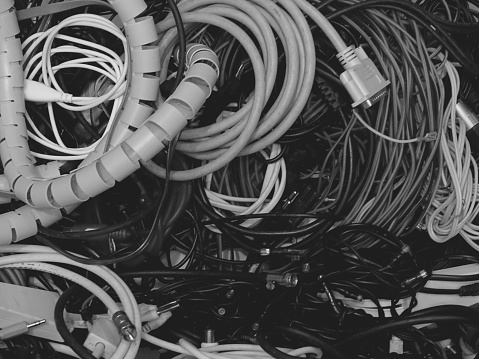 Here is depicted in close-up, a box full of many types of cables, optimized mainly for graphic applications. The photo was shot in mid April 2023, in Dusseldorf, Germany.