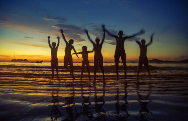 istock kids jumping in the beach 155436879