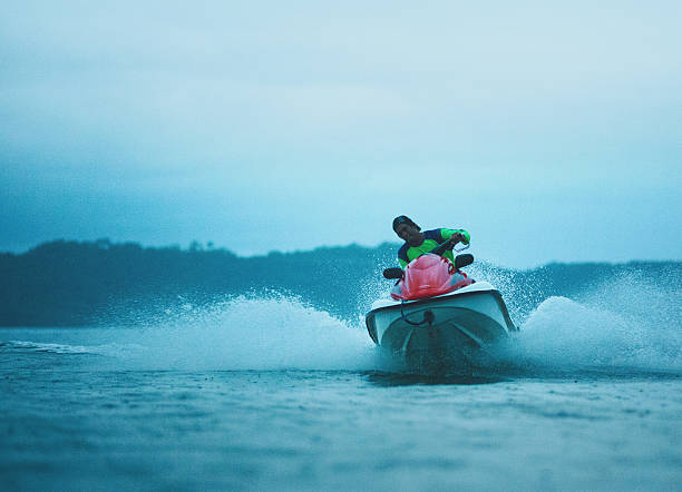 istock man ridding a jet ski 155436937