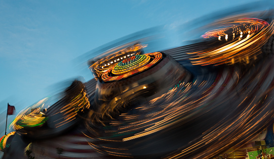 Carnival with fast thrill ride in a carrousel.