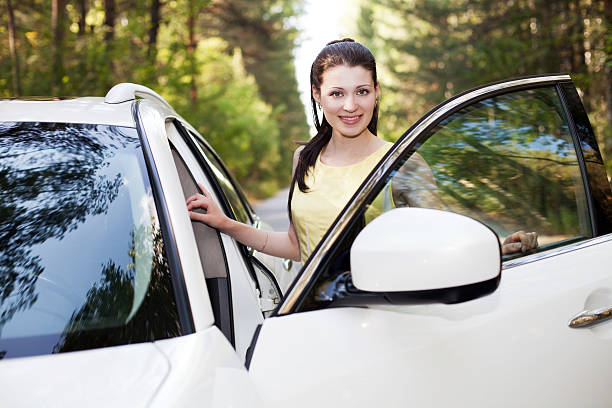 istock Young smiling woman standing near her new car. 155437521