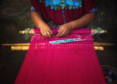 detail of guatemalan mayan woman weaving on loom