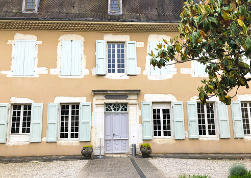 Pau, France - June 24, 2023: Main facade of the medieval castle of Pau which is accessed by a stone bridge, France