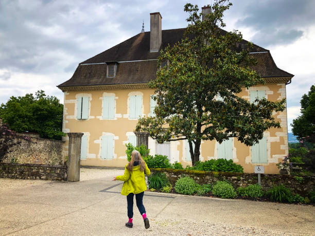 Morestel, Isere, France: A woman walks toward the Maison Ravier Museum in Morestel, a town located between Lyon and Grenoble in the department of Isere. The house belonged to painter A. Ravier, a precursor of Impressionism.