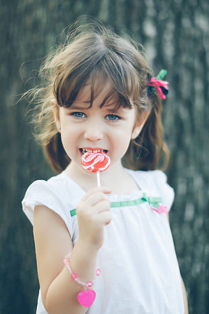 istock girl with a lollipop 155438089