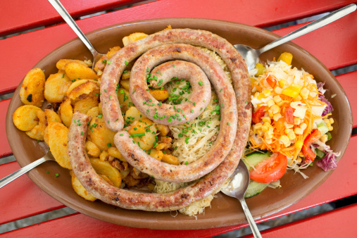 One Meter Long German Sausage prepared with Sauerkraut, salad and potato