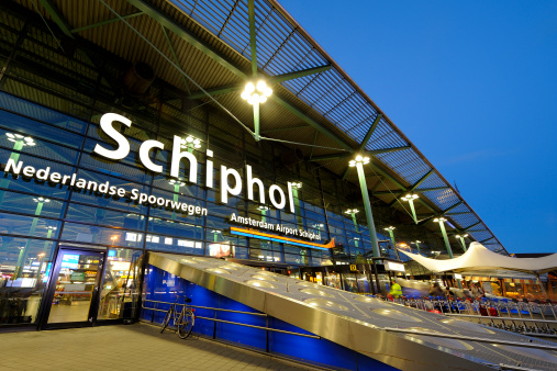 The entrance of Amsterdam Airport Schiphol in the evening. Schiphol is located 9 kilometers southwest of Amsterdam.
