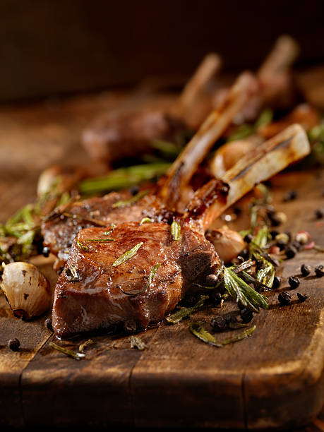 Braised Lamb Chops Rack of Lamb with Garlic, Rosemary and Peppercorns - Photographed on Hasselblad H3D2-39mb Camera rack of lamb stock pictures, royalty-free photos & images