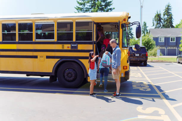 istock Teacher saying goodbye to students after school 1554383419