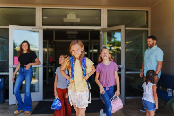 istock Students exiting school building at the end of the day 1554383422