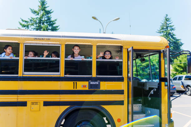 istock Excited kids riding on a school bus 1554383424