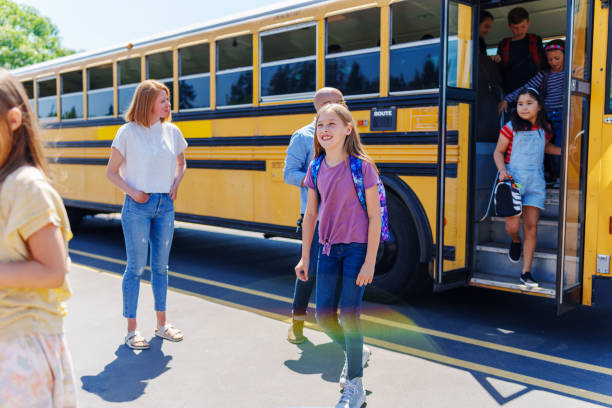 istock Kids arriving at bus stop after school 1554383445