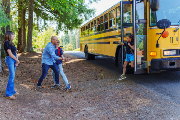istock Dad greeting his son at bus stop after school 1554383466