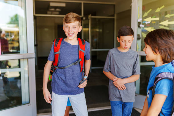 istock Happy male students leaving school 1554383480