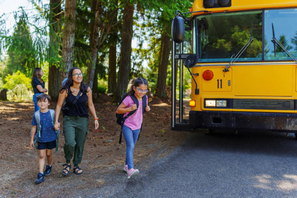 istock Mom walking with her kids home after school 1554384019