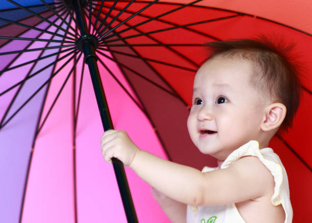 Colorful umbrellas on blue background. Horizontal composition.