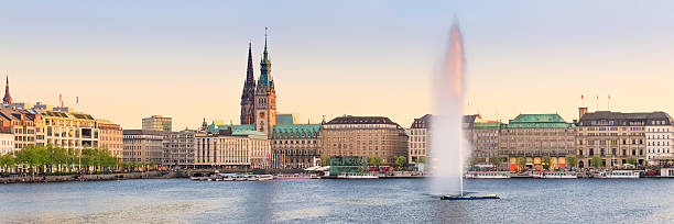 Hamburg Alster Lake panorama The Lake Binnenalster in Hamburg in Germany during spring time. In the foreground the famous Alster Lake fountain. aussenalster lake stock pictures, royalty-free photos & images