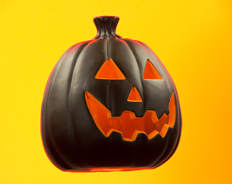 A black Jack O' Lantern on yellow.