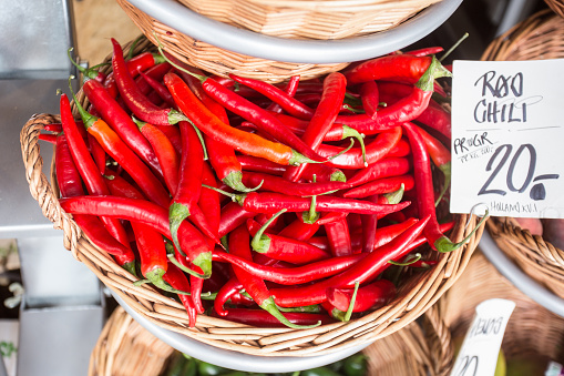 Red Chili Peppers in a basket at an open market in Denmark