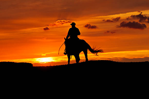 istock Cowboy rides into the sunset 155438824