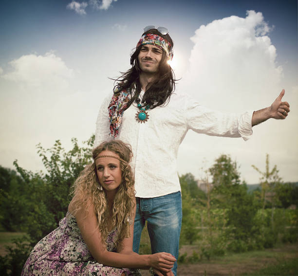 Hippie styled family standing in the field on a sunny summer day.