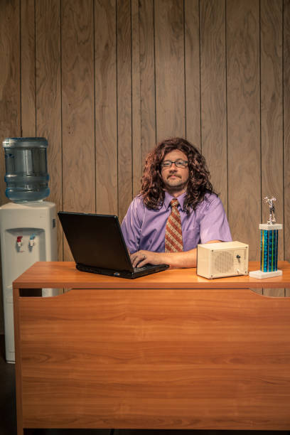 istock Long Hair Shaggy Looking Computer Tech Guy in Retro Office 155439173