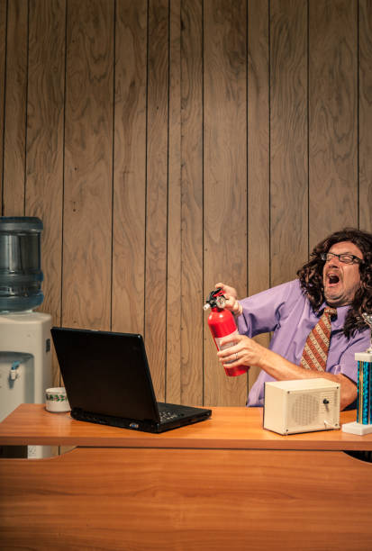 istock Wild and crazy IT man spraying computer with fire extinguisher 155439216