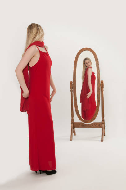 istock Attractive woman in red evening gown-primping/reflection in mirror 155439320
