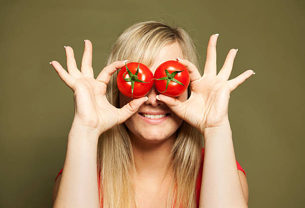 istock Young woman holding tomatos 155439776