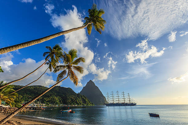 Soufrière Bay, Saint Lucia Magnificent sailing ship moored in the Soufrière Bay, on the southwest coast of Saint Lucia. Founded by the French in 1746, Soufrière was the first town of the island. In the background stands the imposing bulk of the Petit Piton, 743 meters high, one of the two twin volcanic plugs that are the natural landmark of the island. headland photos stock pictures, royalty-free photos & images