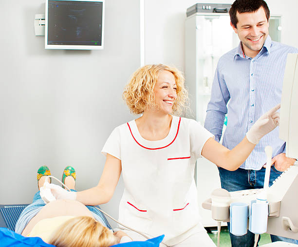 istock Young Couple Looking Baby on ultrasound. 155440055
