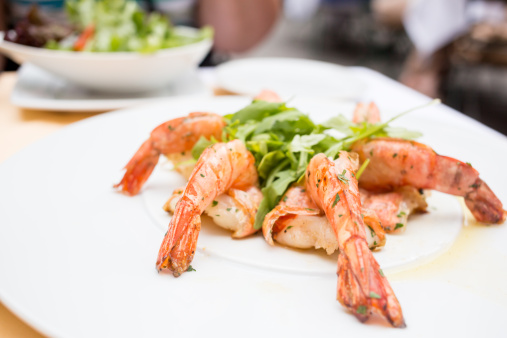 Grilled jumbo shrimp with arugula arranged on a plate
