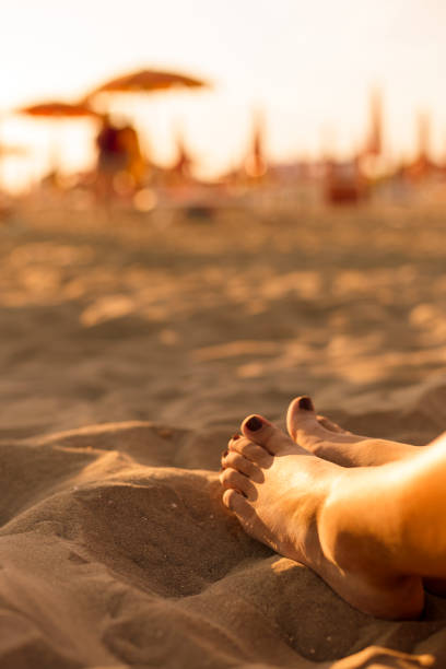 istock Young woman's feet on the beach 155440270
