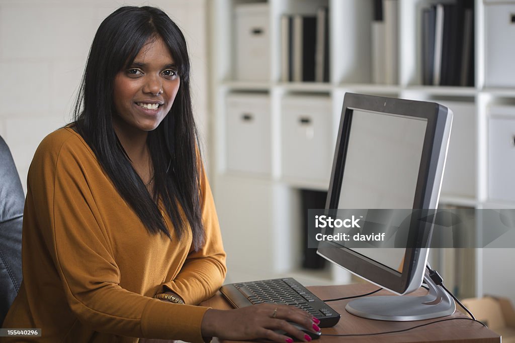 Happy Aboriginal Woman at Work Happy aboriginal woman at work in an office Aboriginal Peoples - Australia Stock Photo