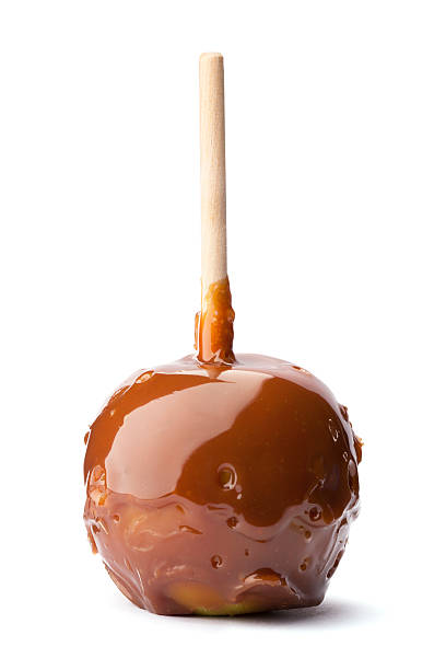 Caramel Apple on a Stick Apple coated in caramel on a stick. taffy apple stock pictures, royalty-free photos & images