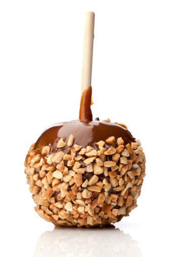 A caramel apple coated with nuts.