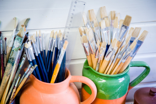 Jugs full of small paint brushes used to make art
