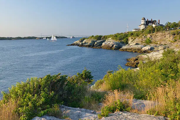 Scenic coast of Newport with view of Newport Bridge and Castle Hill Inn, Rhode Island, USA