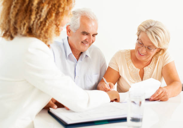 istock Senior Couple Meeting With Financial Advisor. 155440590