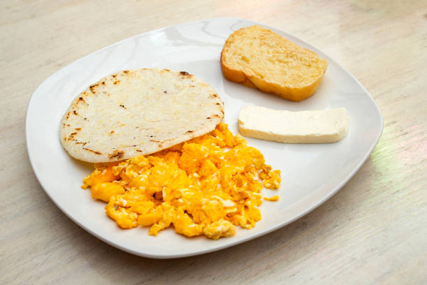 istock Traditional Colombian breakfast - Arepa with cheese, egg and bread 1554406998