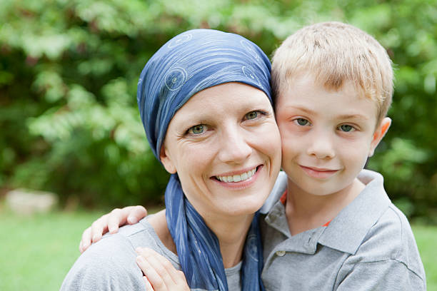 Beautiful young woman with cancer smiling with her son