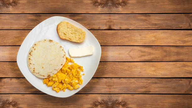 istock Arepa with cheese, egg and bread - Traditional Colombian breakfast 1554407522